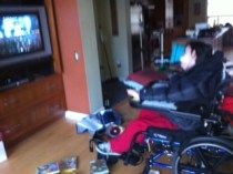 Watching TV in his living room with his videos at his feet. Nothing could be better.