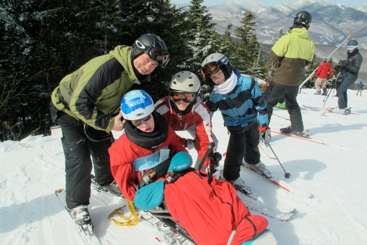 The family at the top of the mountain. Skiing is a winter activity we can all do together.