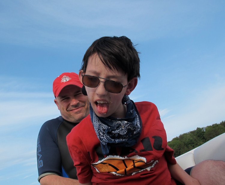 Deane and Dad in a wakeboard boat. Getting out of the cottage is the goal. 